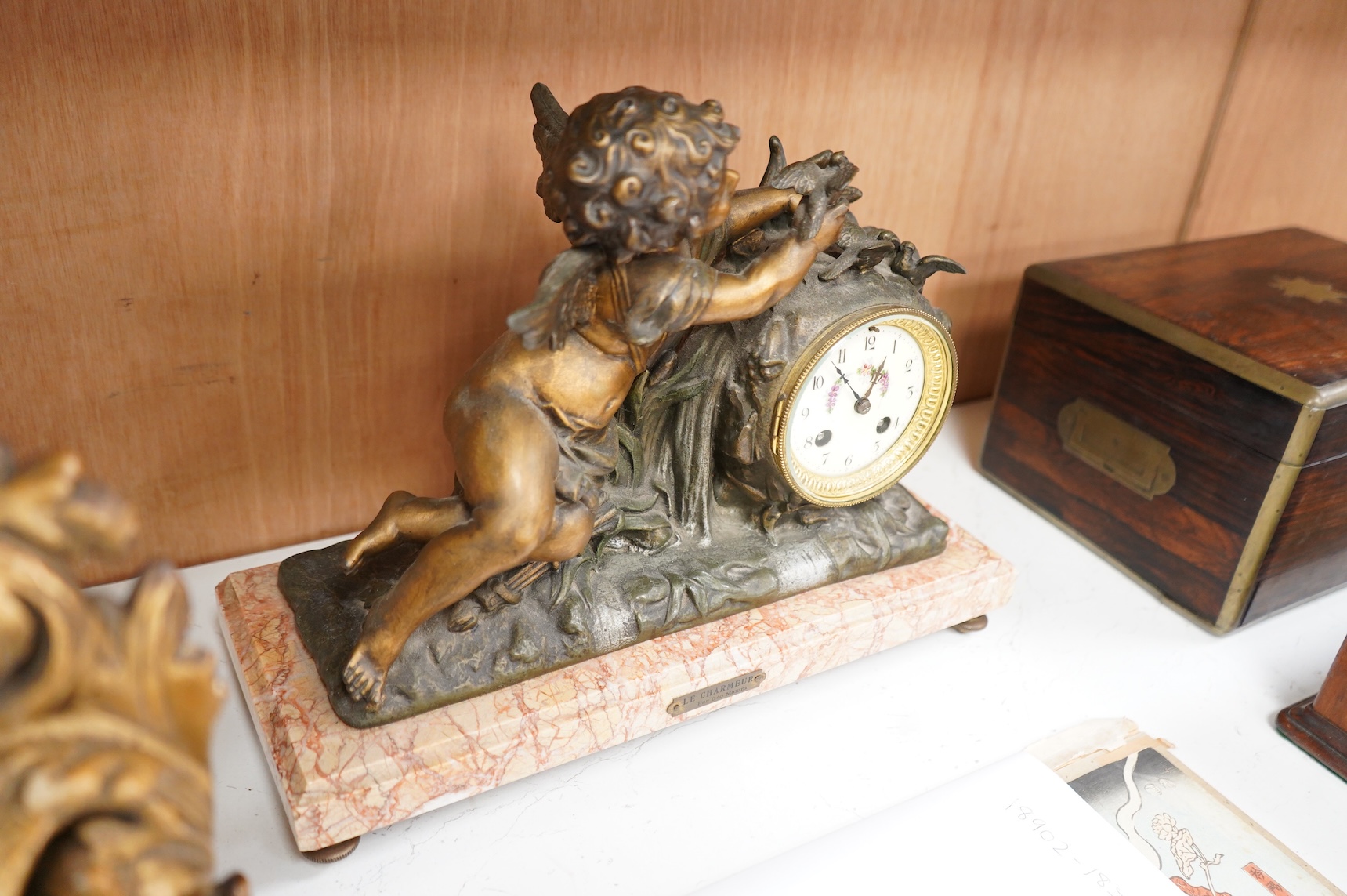 After Georges Maxim (French, 1885-1940), ‘Le Charmeur’, an early 20th century gilt spelter and rouge marble mantel clock, 39cm wide